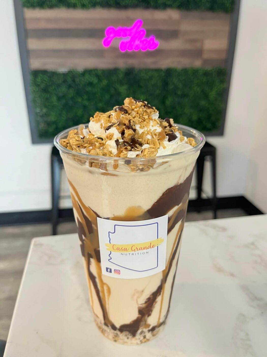 Caramel protein shake topped with whipped cream and granola at Casa Grande Nutrition in Casa Grande AZ