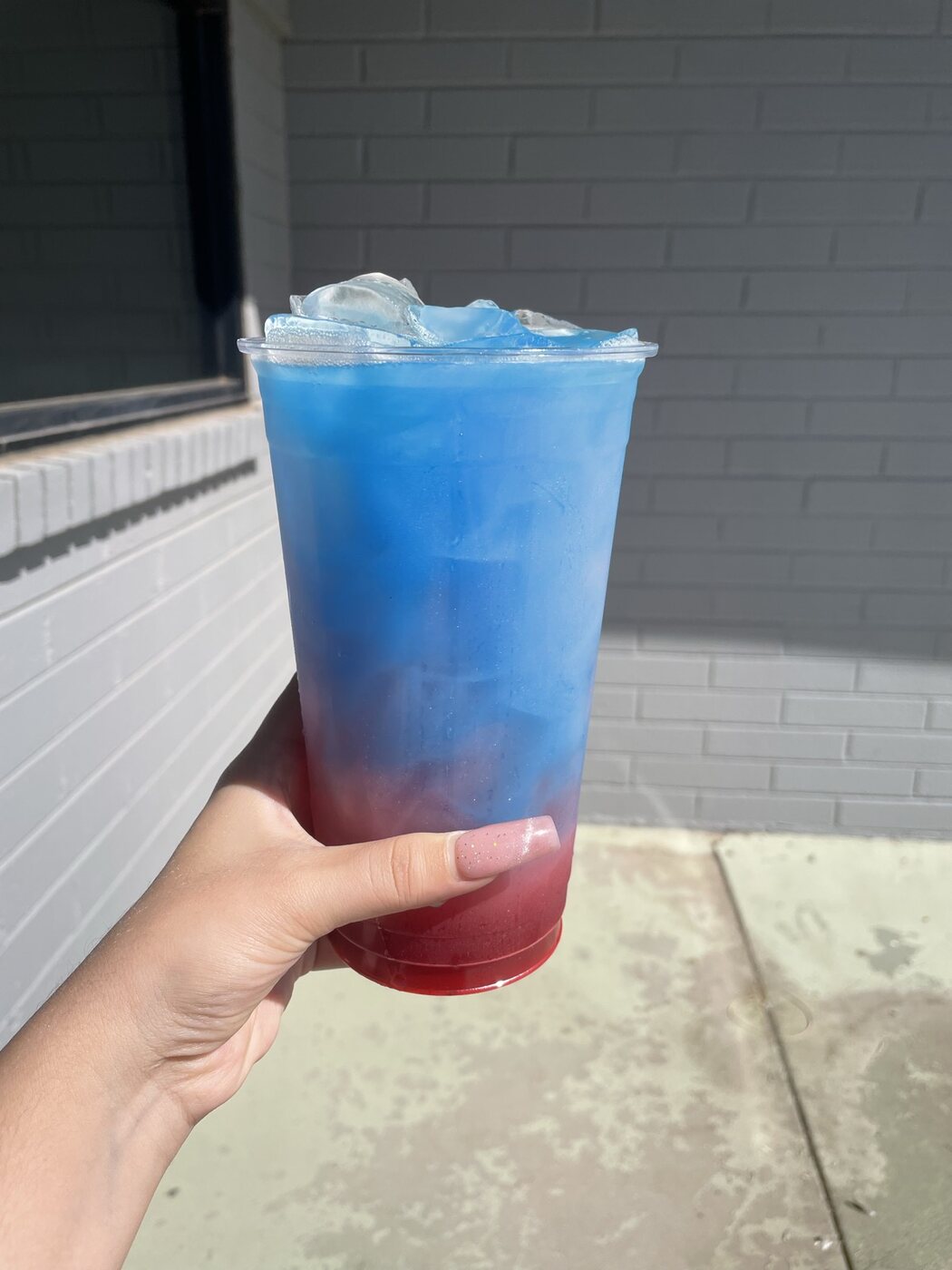 Blue and red layered energy tea in a 32oz cup from Casa Grande Nutrition
